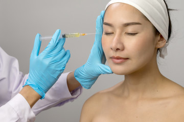 Treatment with botox concept, Asian Woman receiving Botox injection