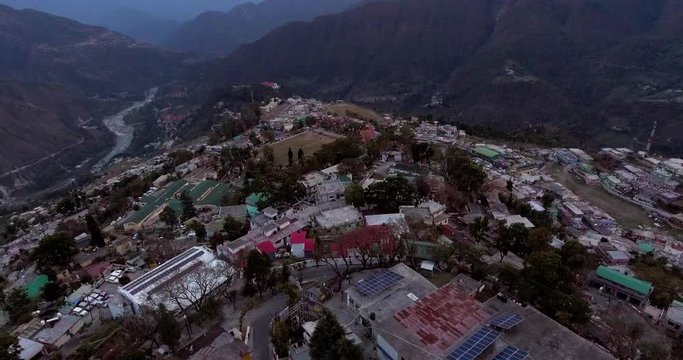 An aerial shot of a beautiful city situated in upper Himalayas- Chamoli, Uttarakhand, India. Uttarakhand hills and mountains.Himalayas peaks at the background.