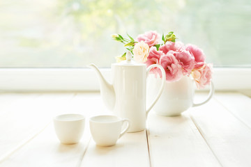 Spring card template. Happy Birthday or Valentine. Women's Day. Greeting card for mother's day. Congratulation with flowers. Flower card. Copy space. Wedding invitation.Tea set with flowers and sweet