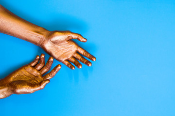 Human hands painted in gold color