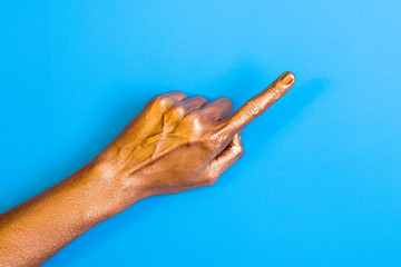 Human hands painted in gold color