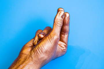 Human hands painted in gold color