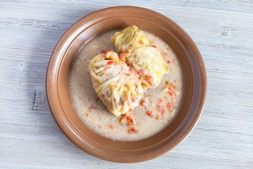 top view of stewed cabbage rolls on gray board