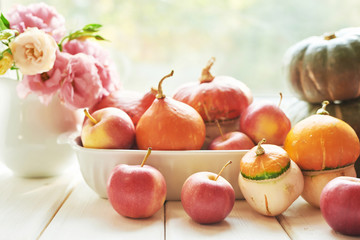 Thanksgiving Day table. Happy Halloween. Pumpkins, apples and flowers. Bright autumn background. Colorful autumn card. Autumn flower arrangement. Autumn bouquet.