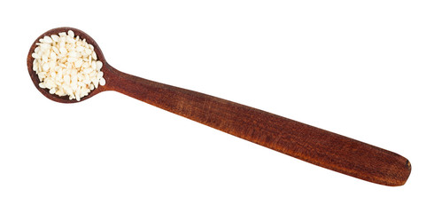 top view of wooden spoon with white sesame seeds