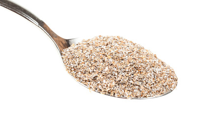 spoon with portion of rye bran close-up isolated
