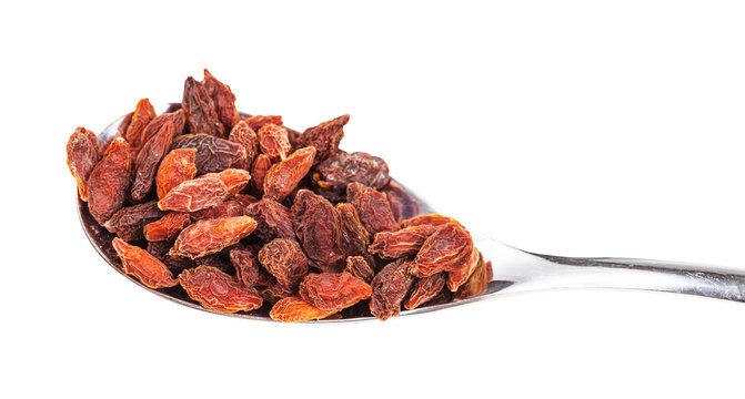 dried goji berries in spoon close-up isolated