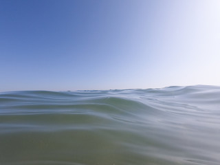 Ocean clear water and blue sky. Algarve Portugal