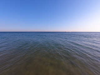 Fototapeta na wymiar Ocean clear water and blue sky. Algarve Portugal