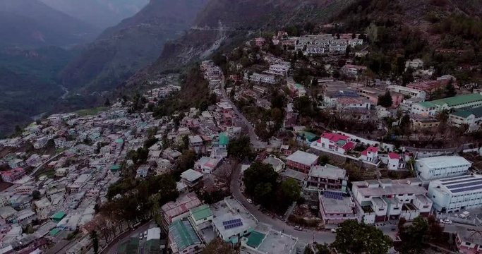 An aerial shot of a beautiful city situated in upper Himalayas- Chamoli, Uttarakhand, India. Uttarakhand hills and mountains.Himalayas peaks at the background.