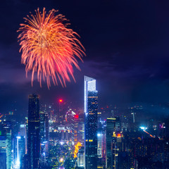 celebration firework with night cityscape of guangzhou urban skyscrapers at storm with lightning  bolts in night purple blue sky, Guangzhou, China