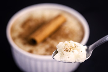 Spoon with rice pudding and cinnamon. Typical dessert from Brazil, a tasty porridge.