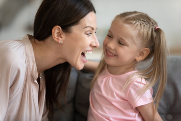 Woman and daughter having fun playing at home