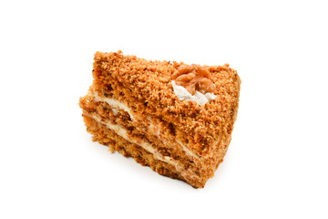 Peace of honey cake isolated on white background.