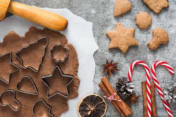 Cooking Christmas gingerbread cookies on gray concrete background. top view