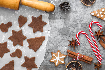 Gingerbread cookies with Christmas decorations on gray concrete background. Christmas cooking food. flat lay