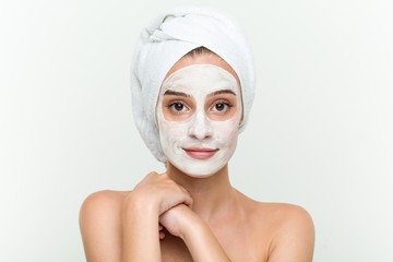 Young caucasian woman enjoying of a facial mask treatment