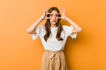 Young caucasian woman keeping eyes opened to find a success opportunity.