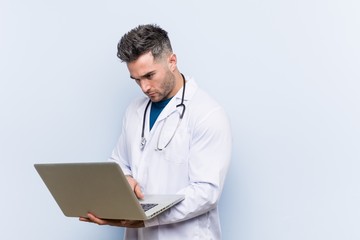 Caucasian doctor man with a laptop