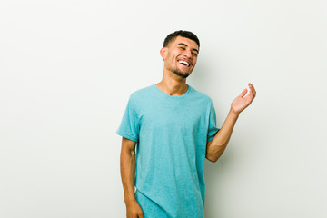 Young hispanic man joyful laughing a lot. Happiness concept.