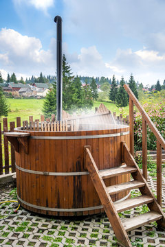 Wooden water spa hot tub with stairs outdoor