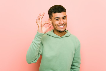 Young hispanic sport man cheerful and confident showing ok gesture.