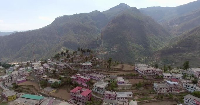 An aerial shot of a beautiful city situated in upper Himalayas- Chamoli, Uttarakhand, India. Uttarakhand hills and mountains.Himalayas peaks at the background.
