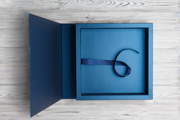 stylish square cardboard box for a photo album. open blue cardboard box for a photo book Open box...
