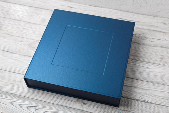 stylish designer square box for photo books... cardboard box for a photo album. Box for wedding album on the wooden background. Gift box with lid.
