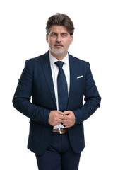 Confident businessman adjusting his jacket while walking