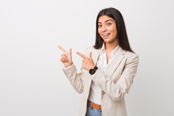 Young business arab woman isolated against a white background pointing with forefingers to a copy...