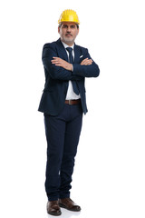 Smart businessman wearing a safety cap and a blue suit