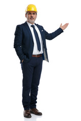 Modern businessman presenting and wearing a construction cap