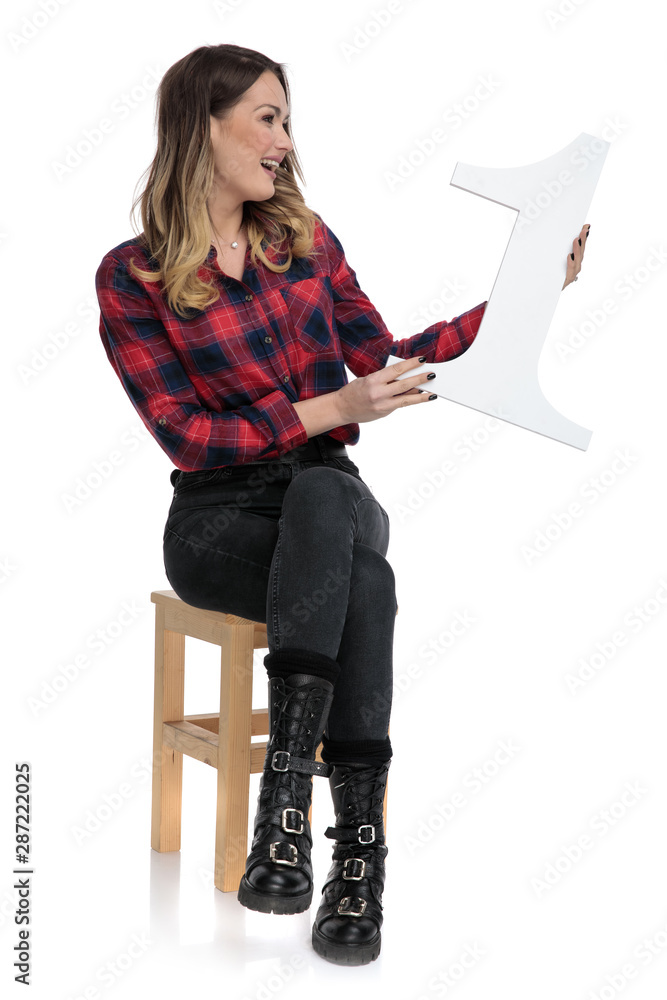 Canvas Prints casual woman sitting and presenting number one to a side