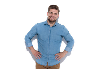 relaxed happy casual man standing with hands on waist