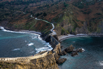 Aerial panorama of the scenic bridge connecting San Juan de Gaztelugatxe islet with the mainland, Bermeo, Basque Country, Spain