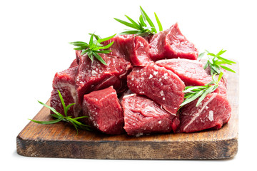 Sliced raw beef with tarragon herb isolated on white