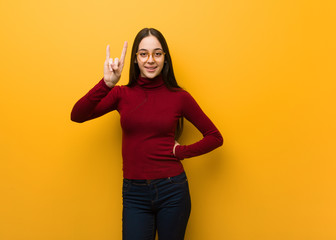 Intellectual young girl doing a rock gesture