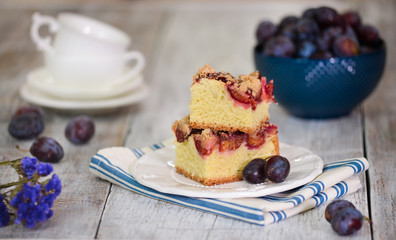 Rustic style. Homemade plum cake on wooden table