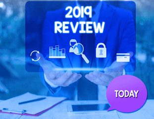 Text sign showing 2019 Review. Business photo text New trends and prospects in tourism or services for 2019 man icons smartphone speech bubble office supplies technological device