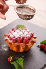 raspberry cake on a black plate