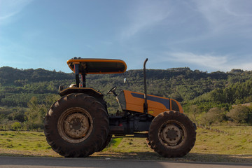 Rural side tractor in the field with blue sky