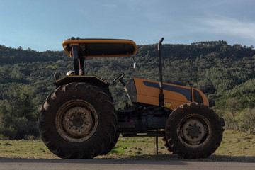 Rural side tractor in the field with blue sky