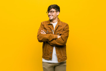 Young hispanic casual man smiling confident with crossed arms.