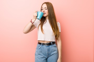Young caucasian woman holding a cup