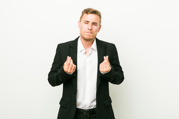 Young caucasian business man showing that she has no money.