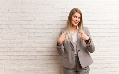 Young russian business woman surprised, feels successful and prosperous