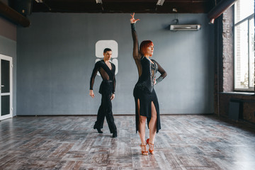 Man and woman on ballrom dance training in class