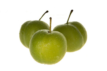 heap of green cherry-plum isolated on white background