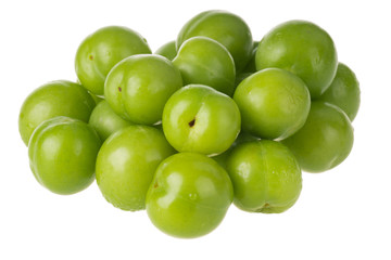 heap of green cherry-plum isolated on white background